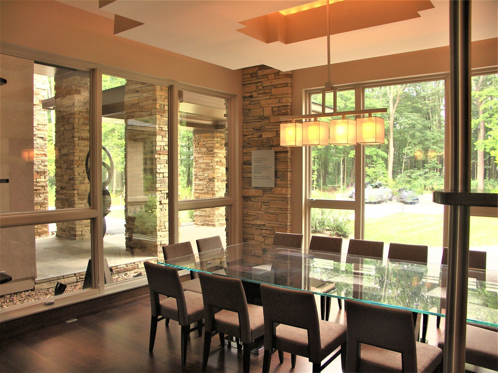A Dining Room With A Long Glass Table And Chairs - Carmel, IN - Goldberg Design Group