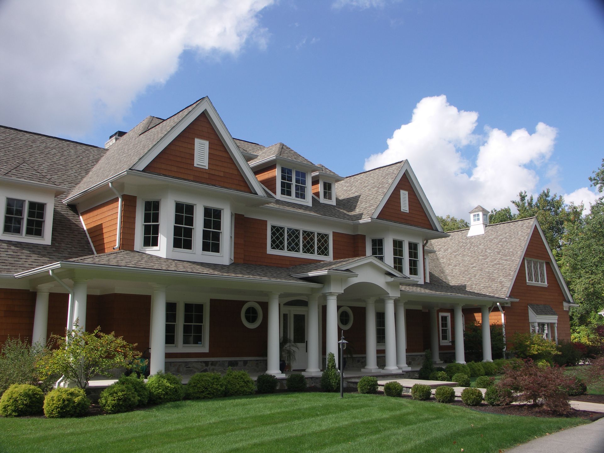 A Large Shingle Brick House With A Gray Roof - Carmel, IN - Goldberg Design Group