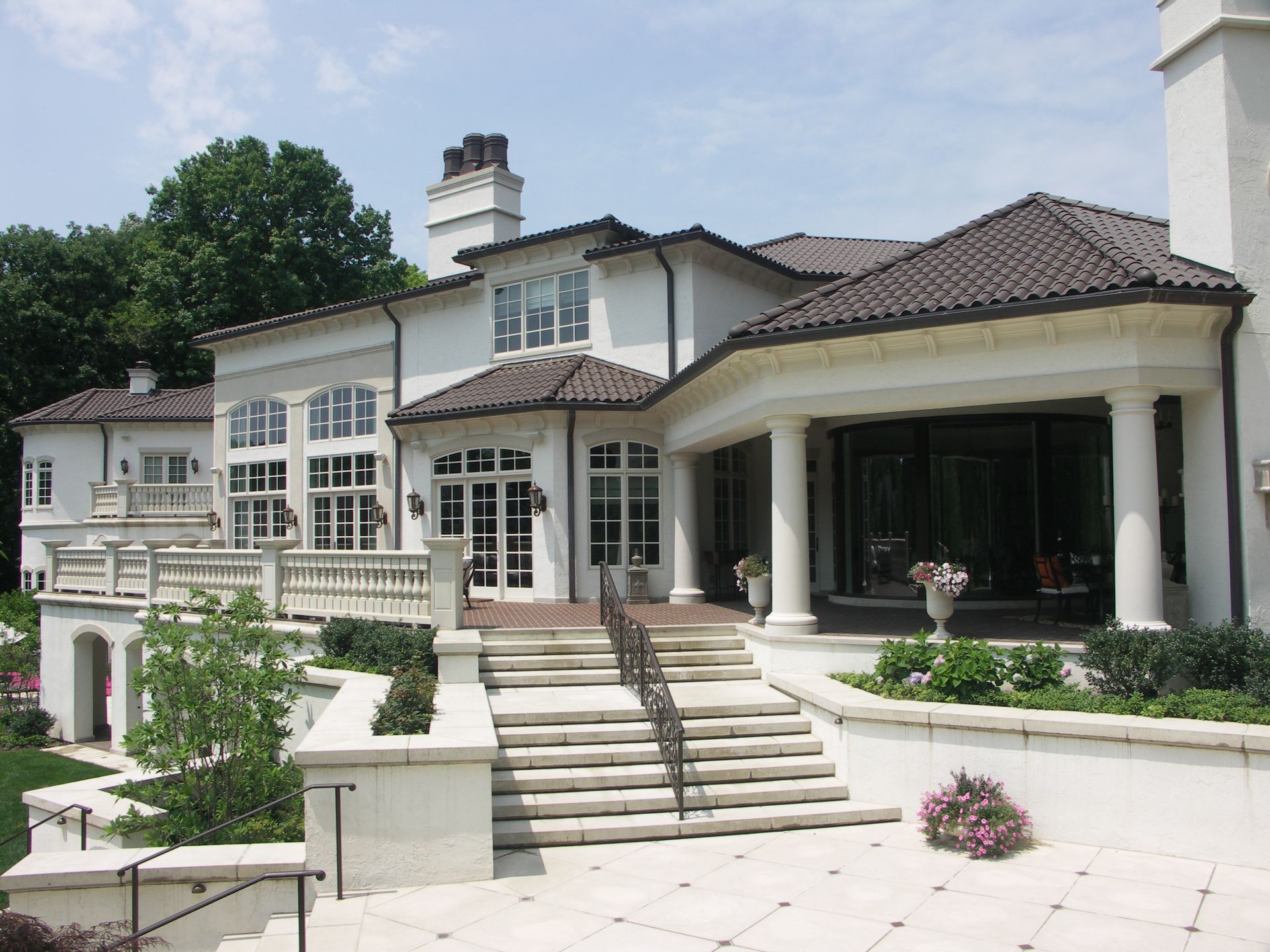 A Large White House With Stairs Leading Up To It - Carmel, IN - Goldberg Design Group