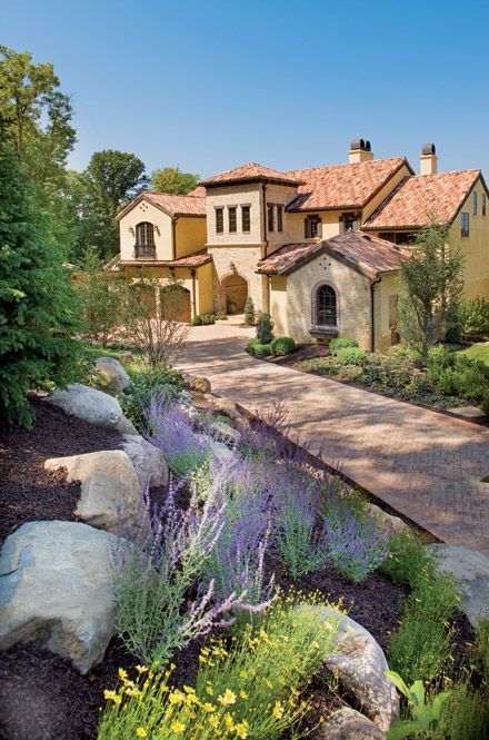 A Large House With A Lot Of Windows Is Lit Up At Night - Carmel, IN - Goldberg Design Group