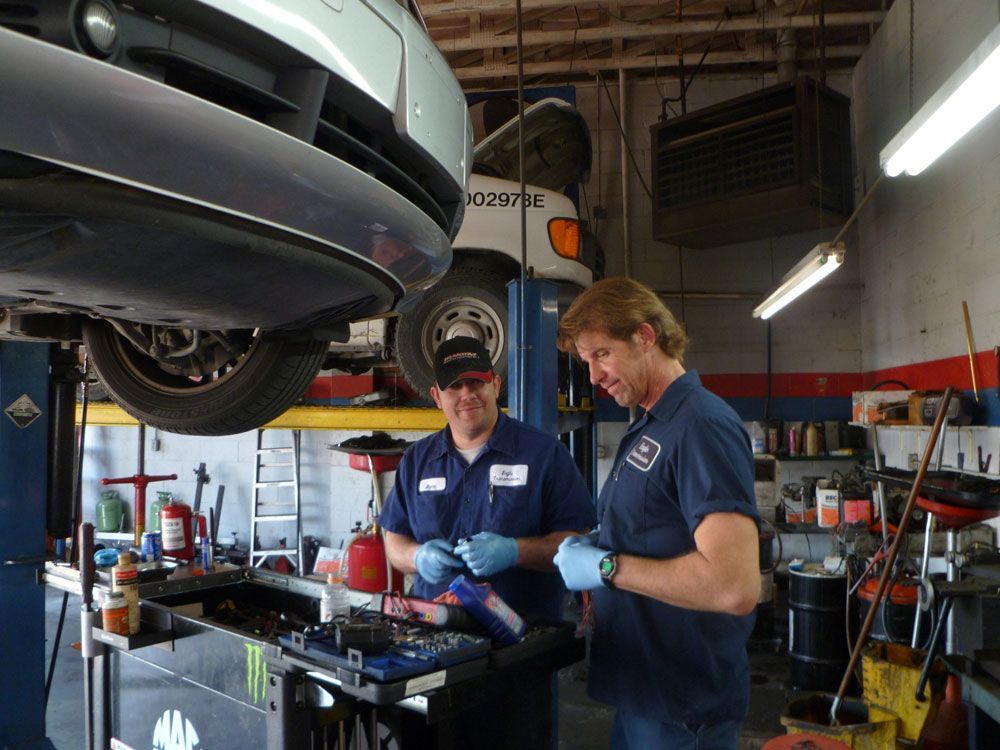 Two men in garage working on cars | Eagle Transmission & Auto Repair - Austin-North
