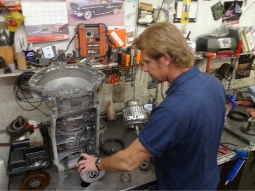 Man looking closely at transmission | Eagle Transmission & Auto Repair - Austin-North