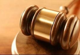 Un primer plano del mazo de un juez sobre una mesa de madera.