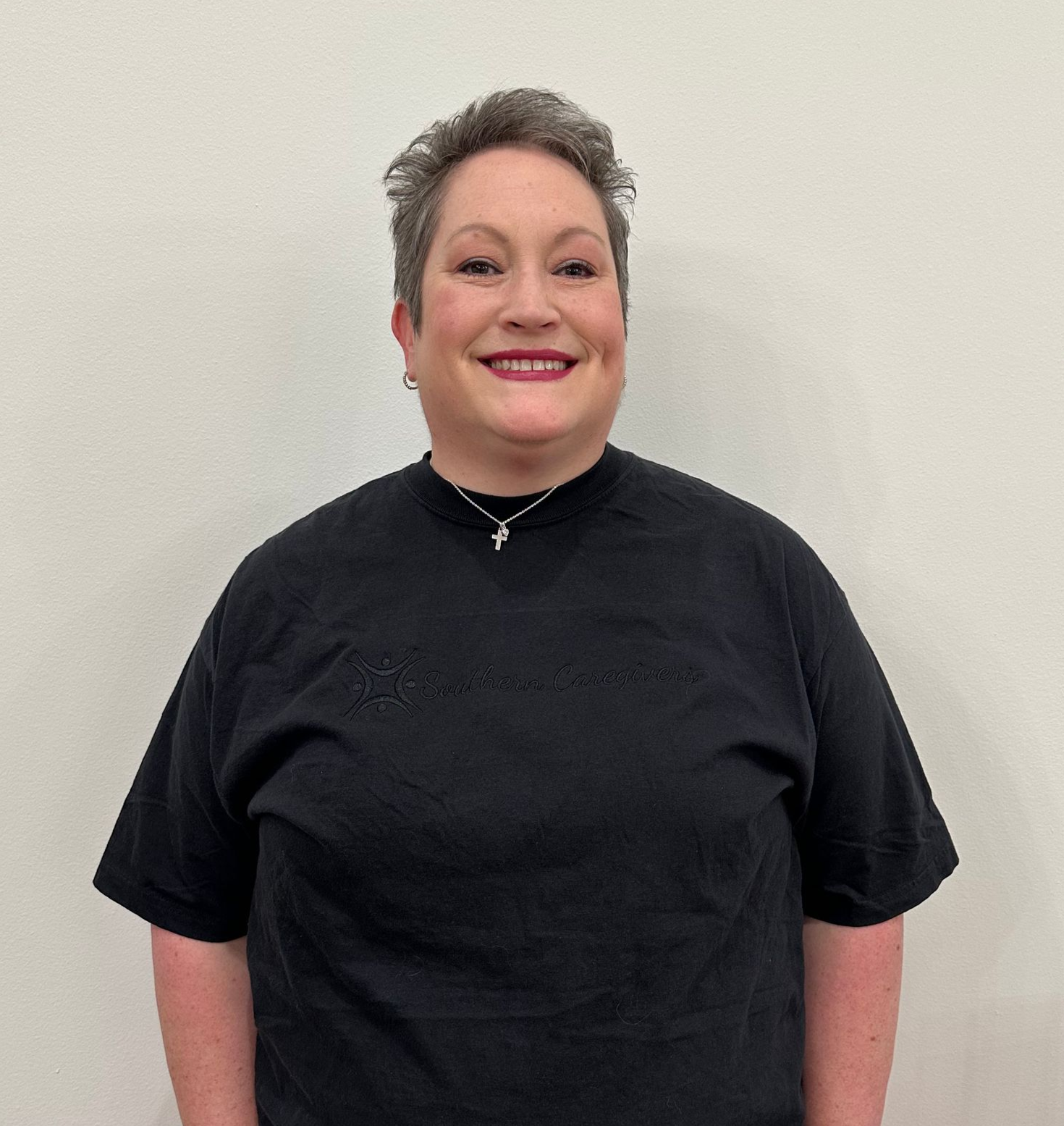 A woman wearing a red shirt that says southern caregivers