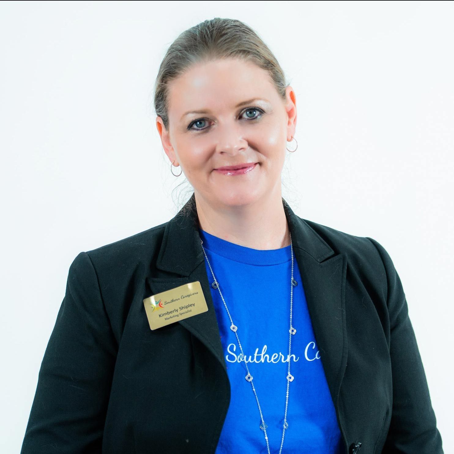A woman wearing a blue shirt that says southern caregivers.caregiver in jonesboro