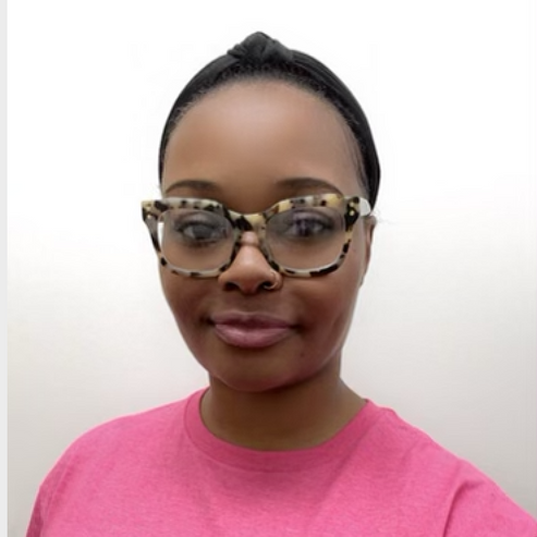 A woman wearing glasses and a pink southern caregivers shirt. caregiver in jonesboro