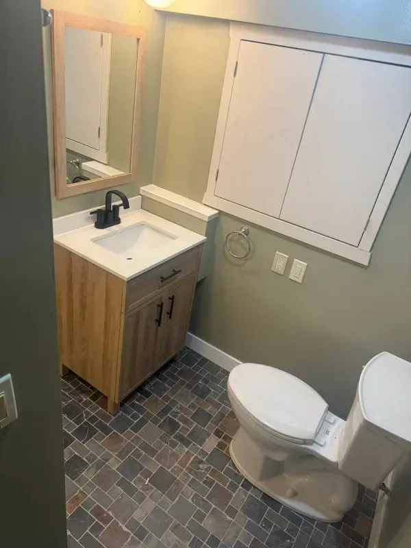 Shower with frosted glass doors, chrome fixtures, and a toilet.