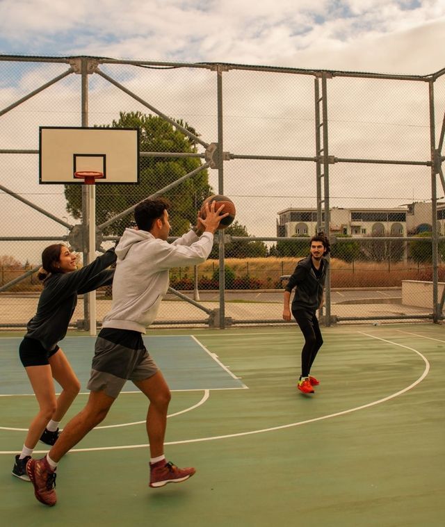 Three friends playing a pickup game of basketball.