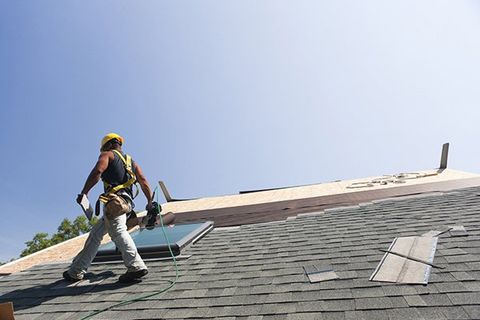 Worker Fixing Asphalt Shingles Roof — North Webster, IN — Lake City Builders II LLC
