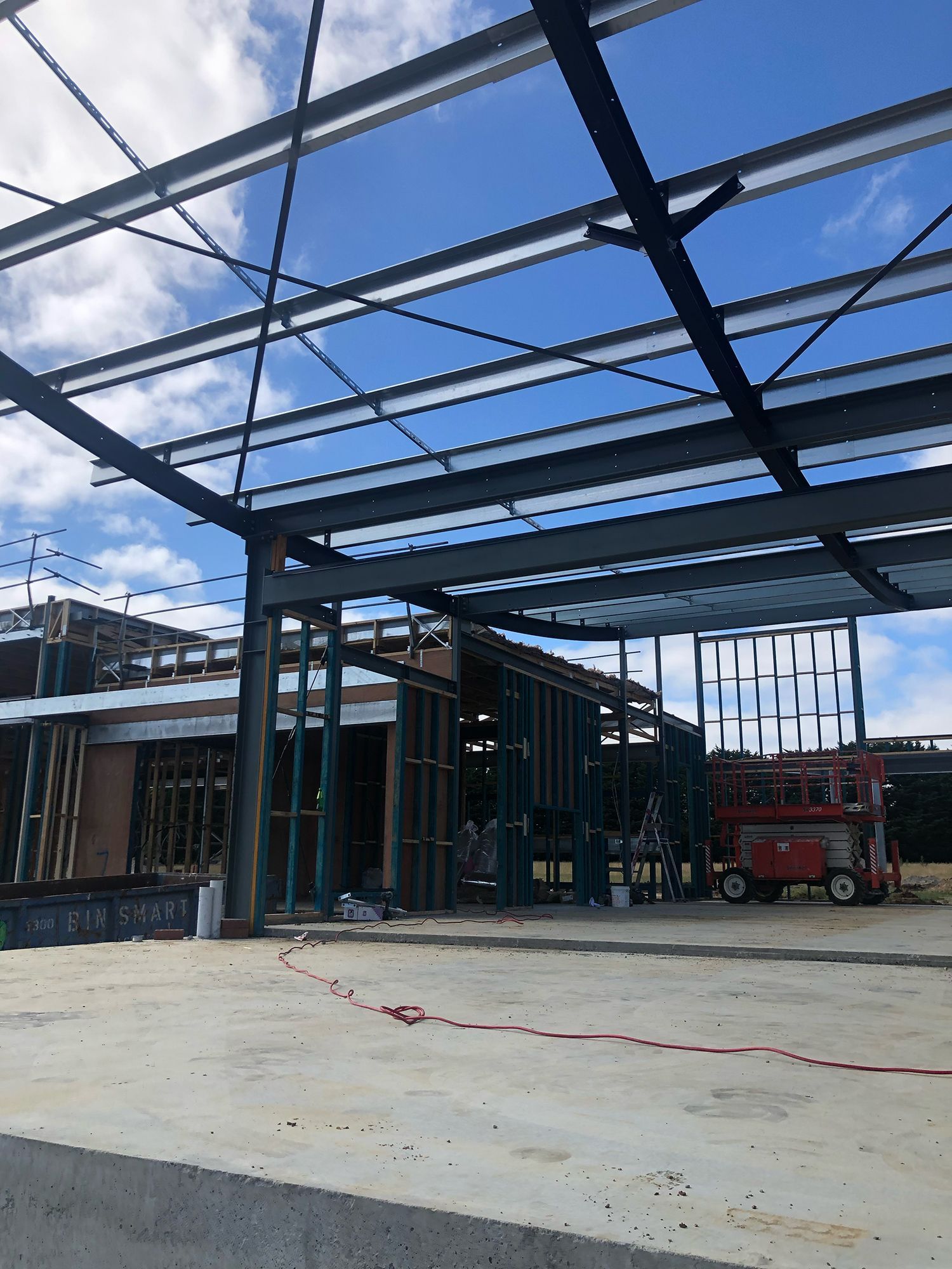 A large building under construction with a blue sky in the background