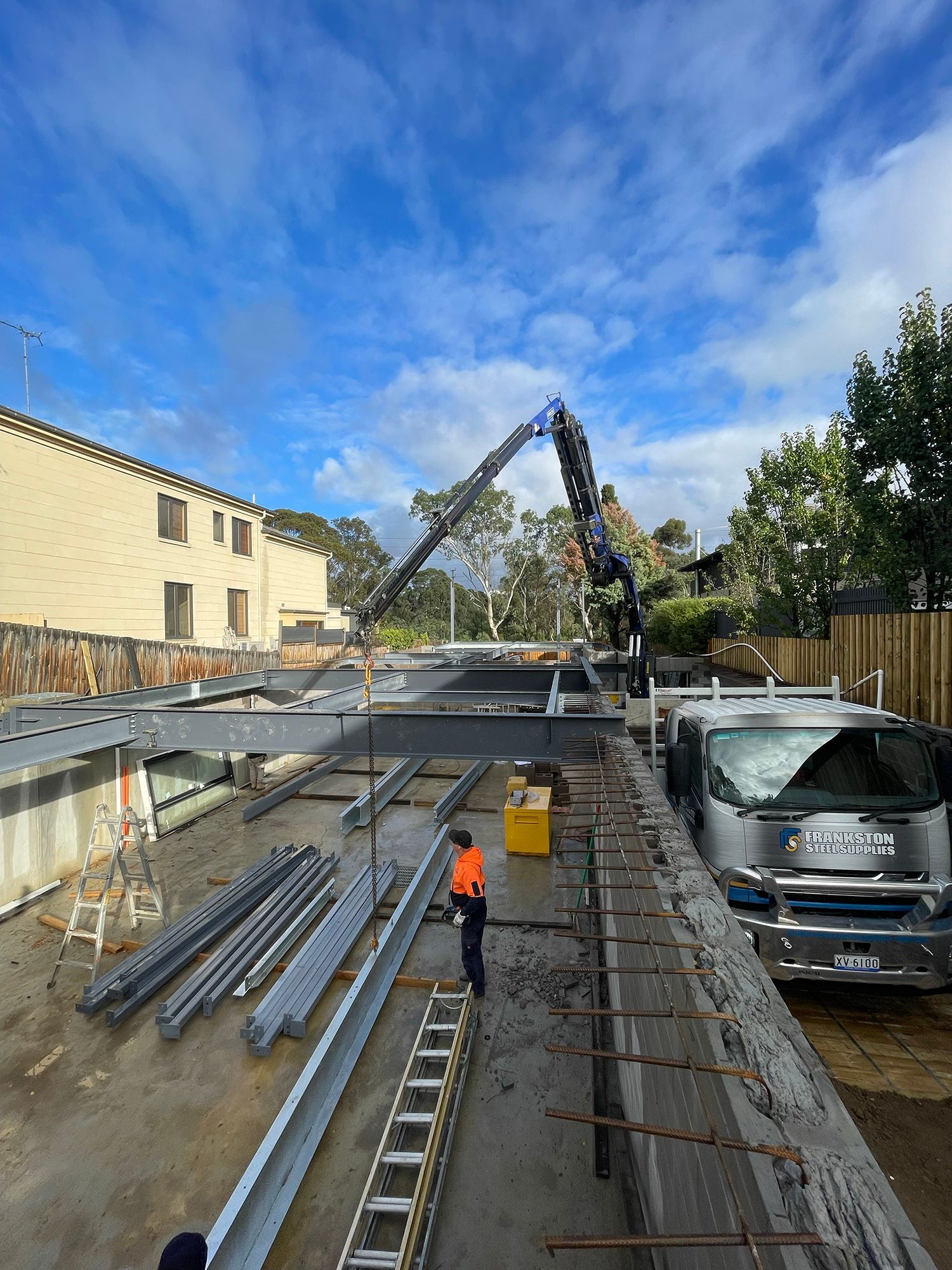 A construction site with a crane and a truck.