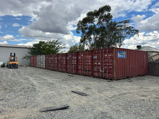 Container storage units lined up on a gravel lot