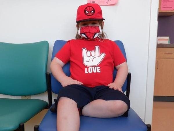 Child in Spider-Man hat and mask, red 