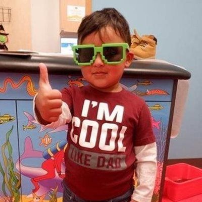 Young child wearing pixelated sunglasses and a 