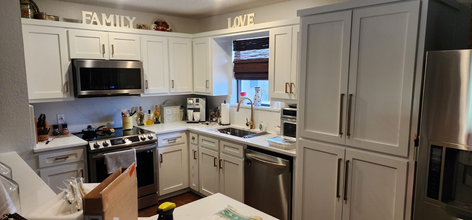 A bright kitchen with white cabinets.