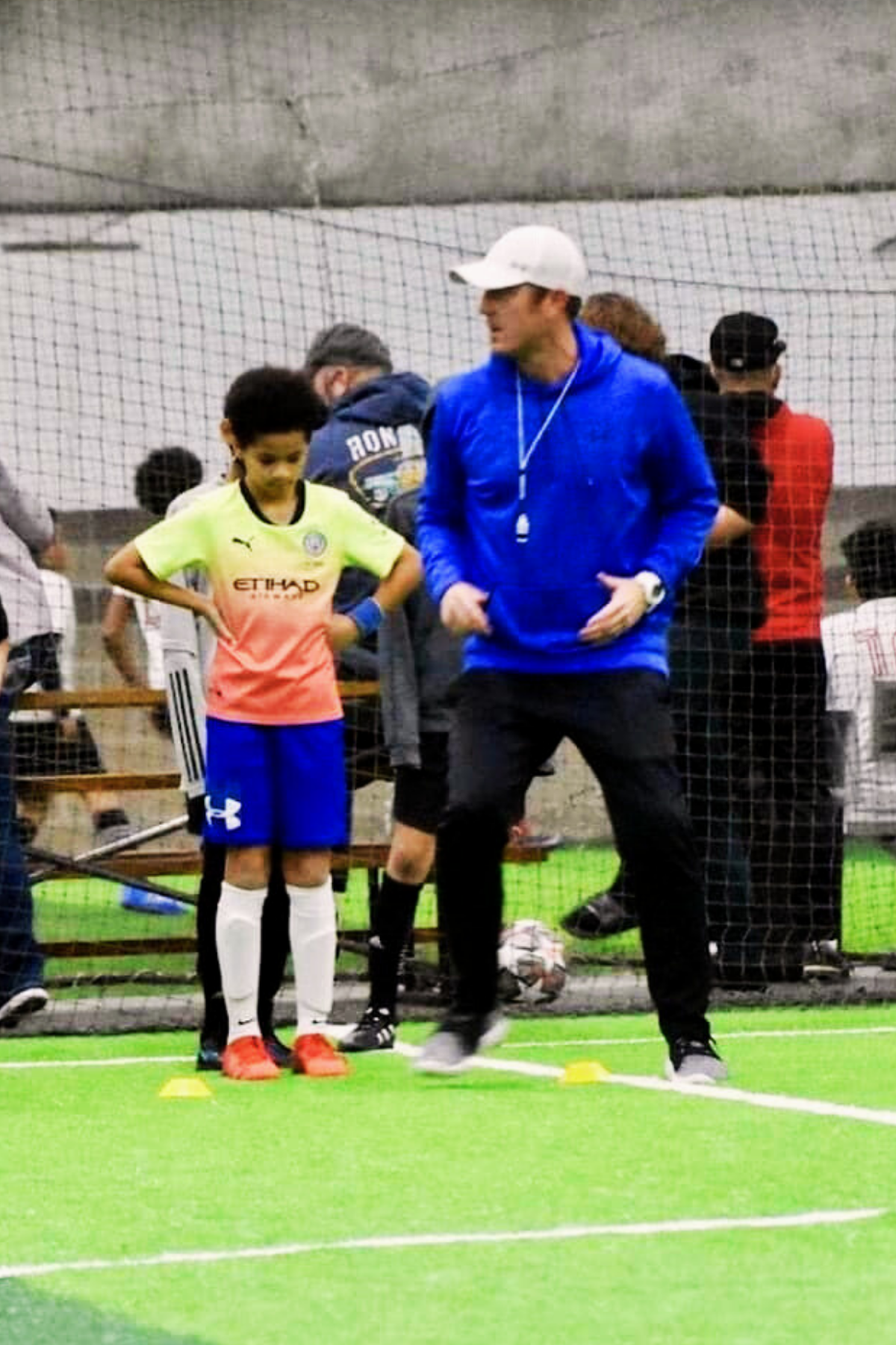 Owner Mike Lookingland coaching kids' soccer