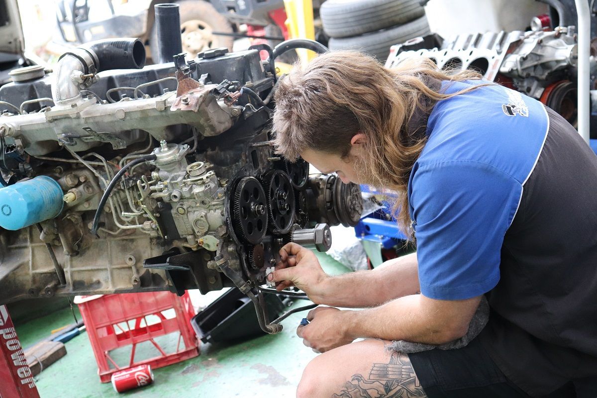 Mechanic Working On Car Engine In Blue And Black Shirt — Ballina Car Centre in Ballina, NSW