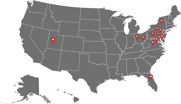 Gray U.S. map with red location pins clustered in the Northeast and one in the West, plus one in Florida
