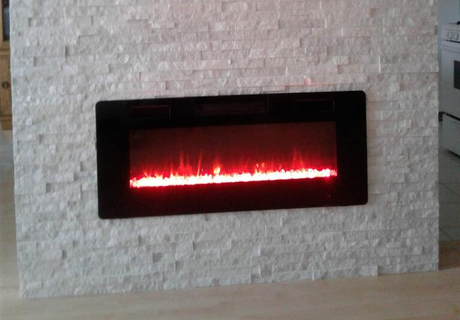 modern style built in electrical fireplace inserted into brick wall pillar designed with quartz bricks for new home remodeled fireplace.