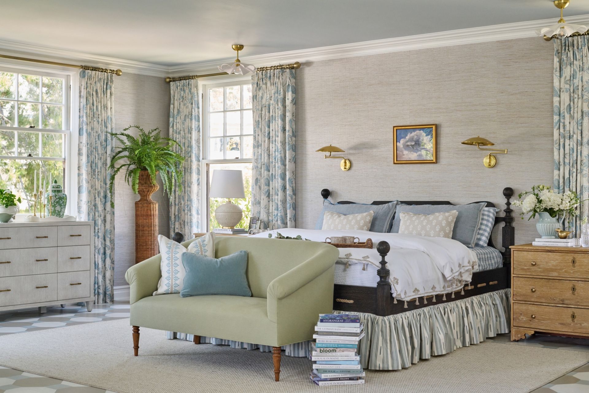 Bedroom with bed, loveseat, and dresser in shades of blue, green, and white; natural light.