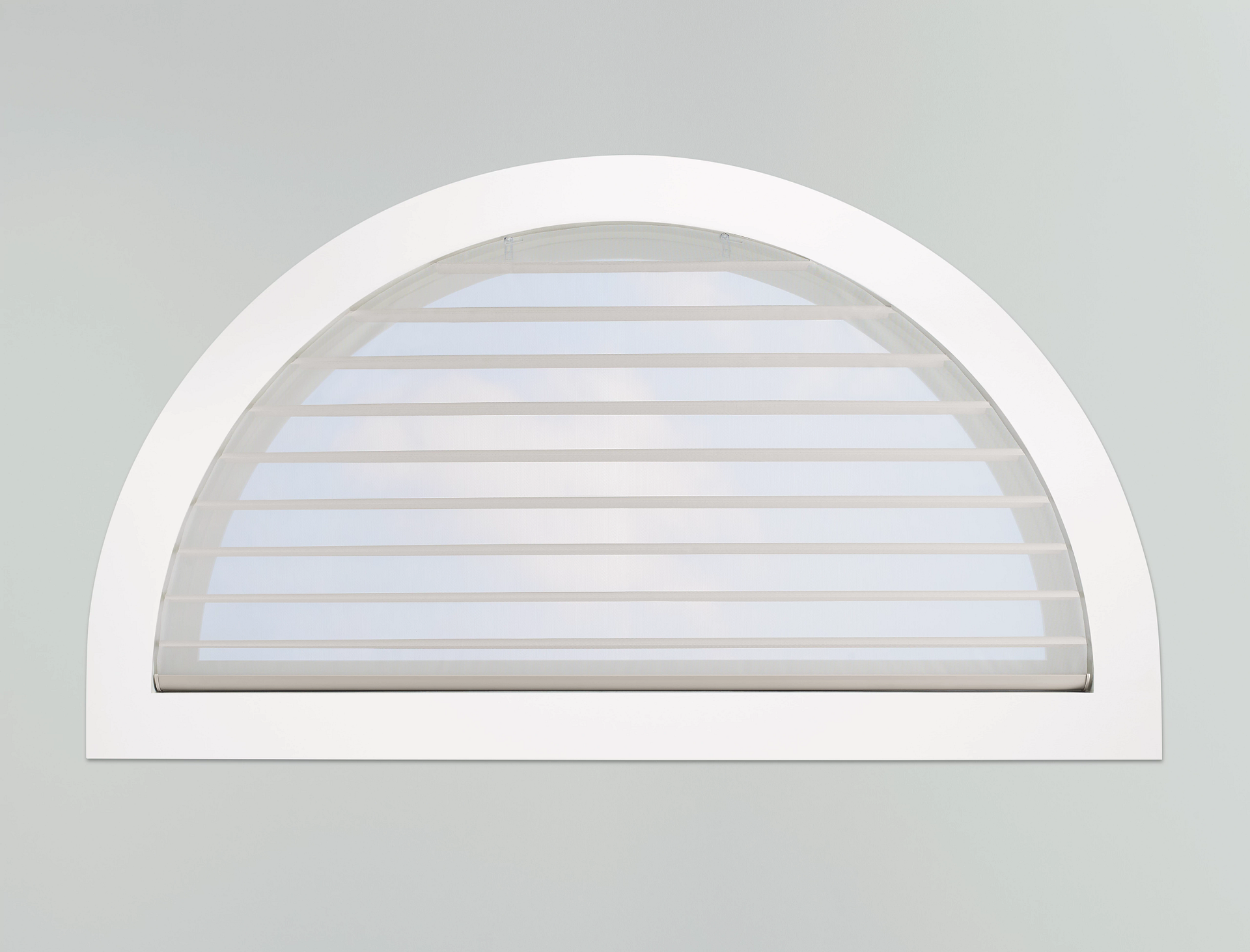 White arched window with horizontal blinds.