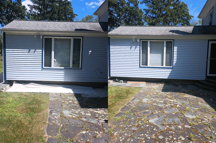 A light blue house with a window, before and after cleaning. The stone patio in front is also cleaned.