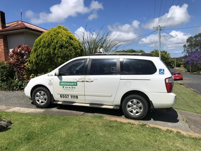 A White Van Is Parked on The Side of The Road in Front of A House — Greenaway's Taxi in Wingham, NSW