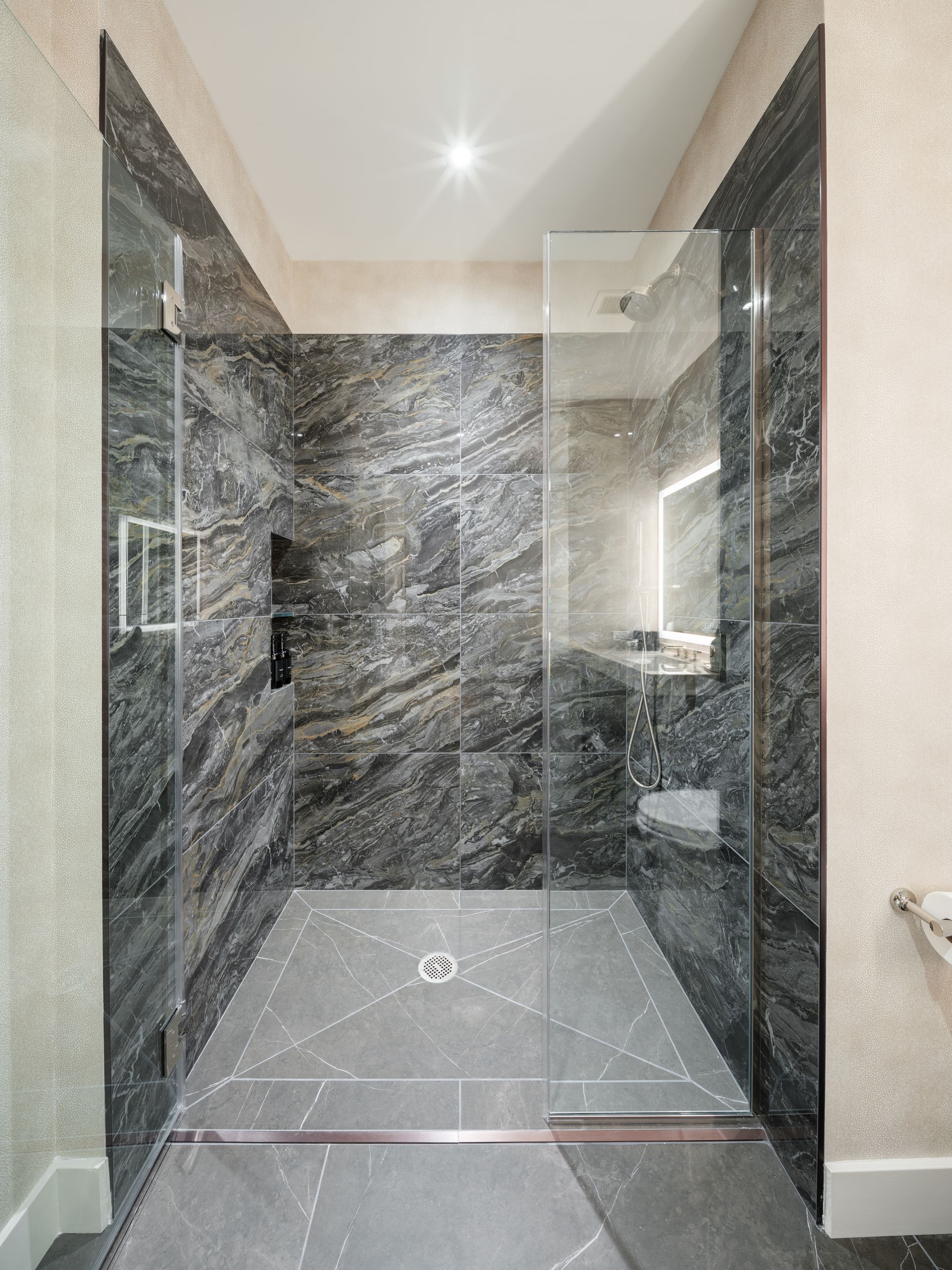 A bathroom with a walk in shower and a toilet.