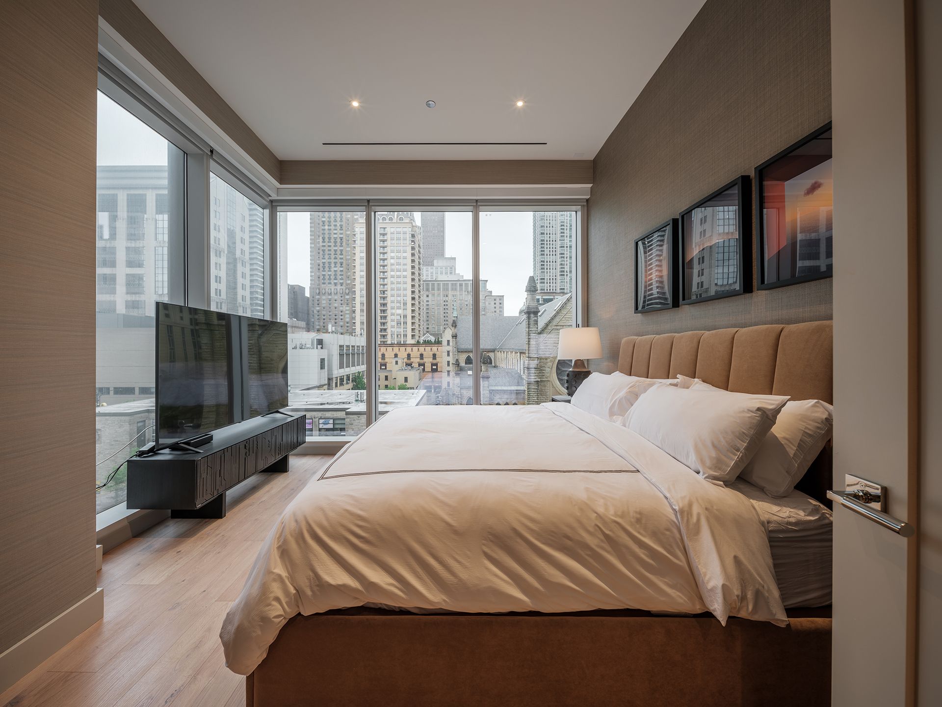 A bedroom with a king size bed and a flat screen tv.