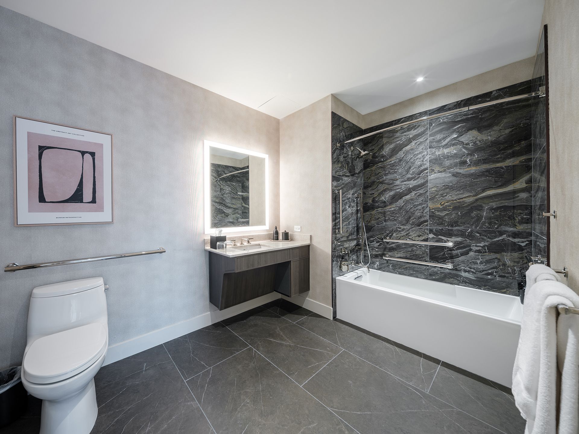 A bathroom with a toilet , sink and bathtub.