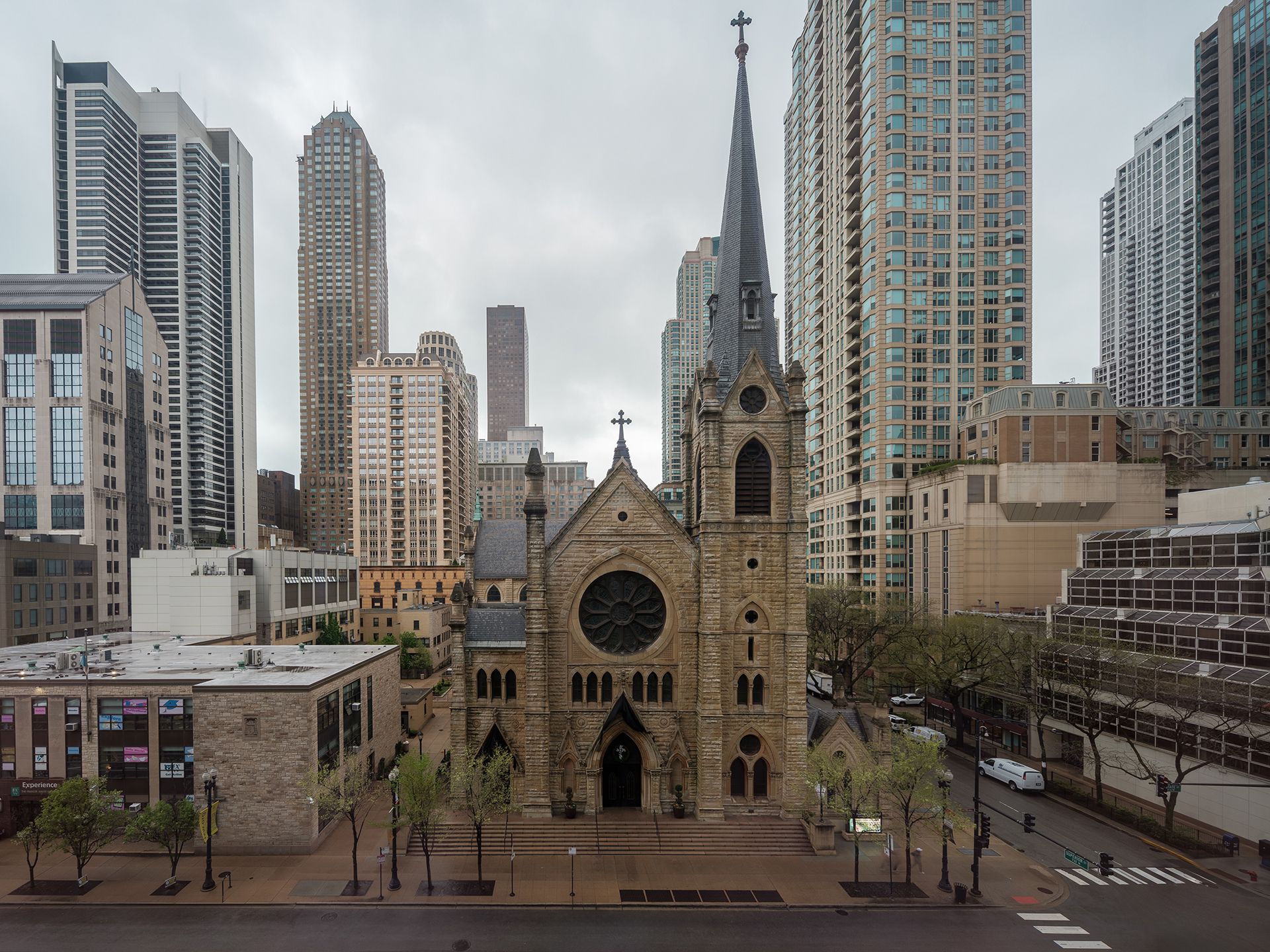 A church in the middle of a city surrounded by tall buildings