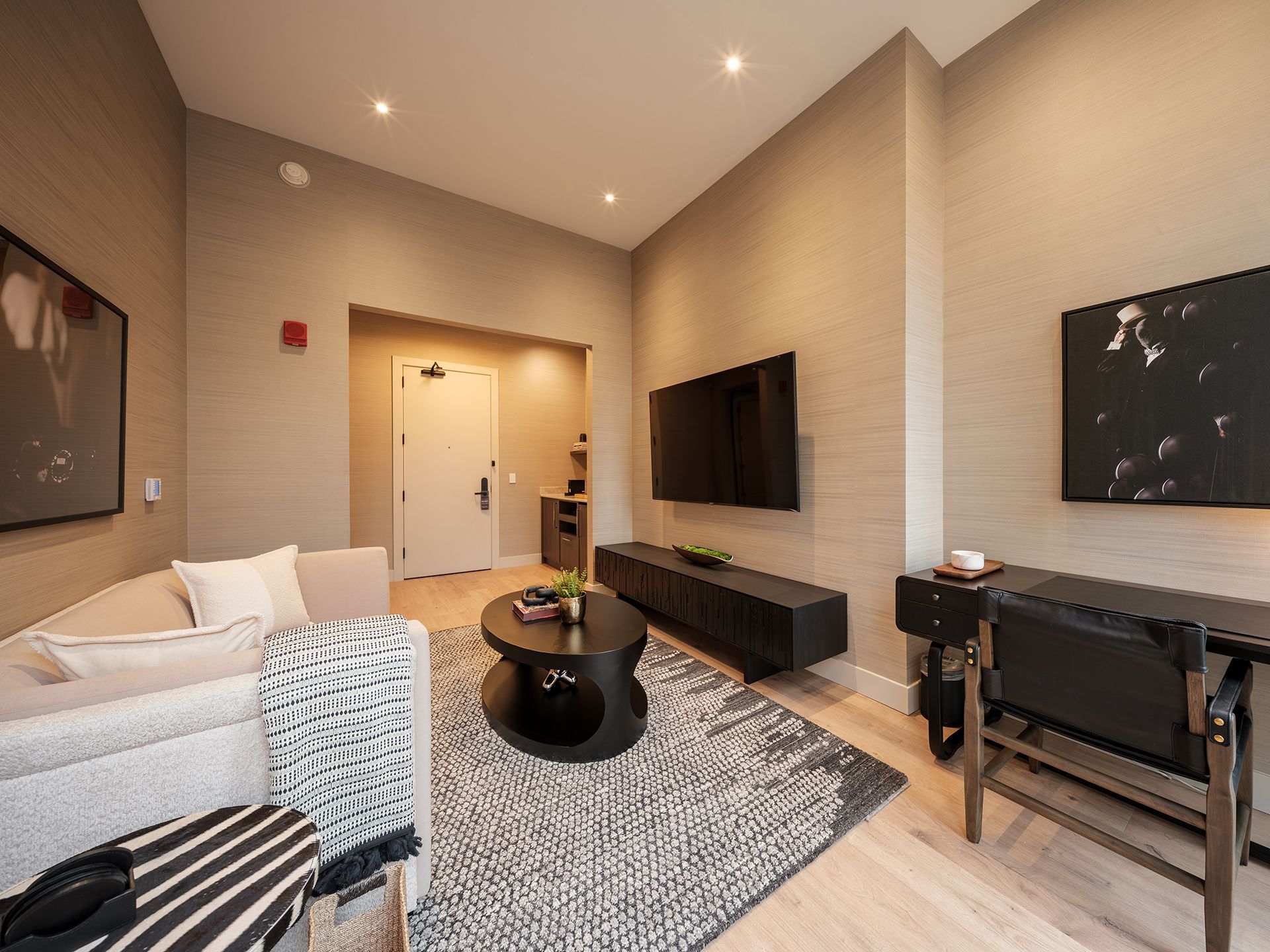 A living room with a couch , chair , coffee table and television.