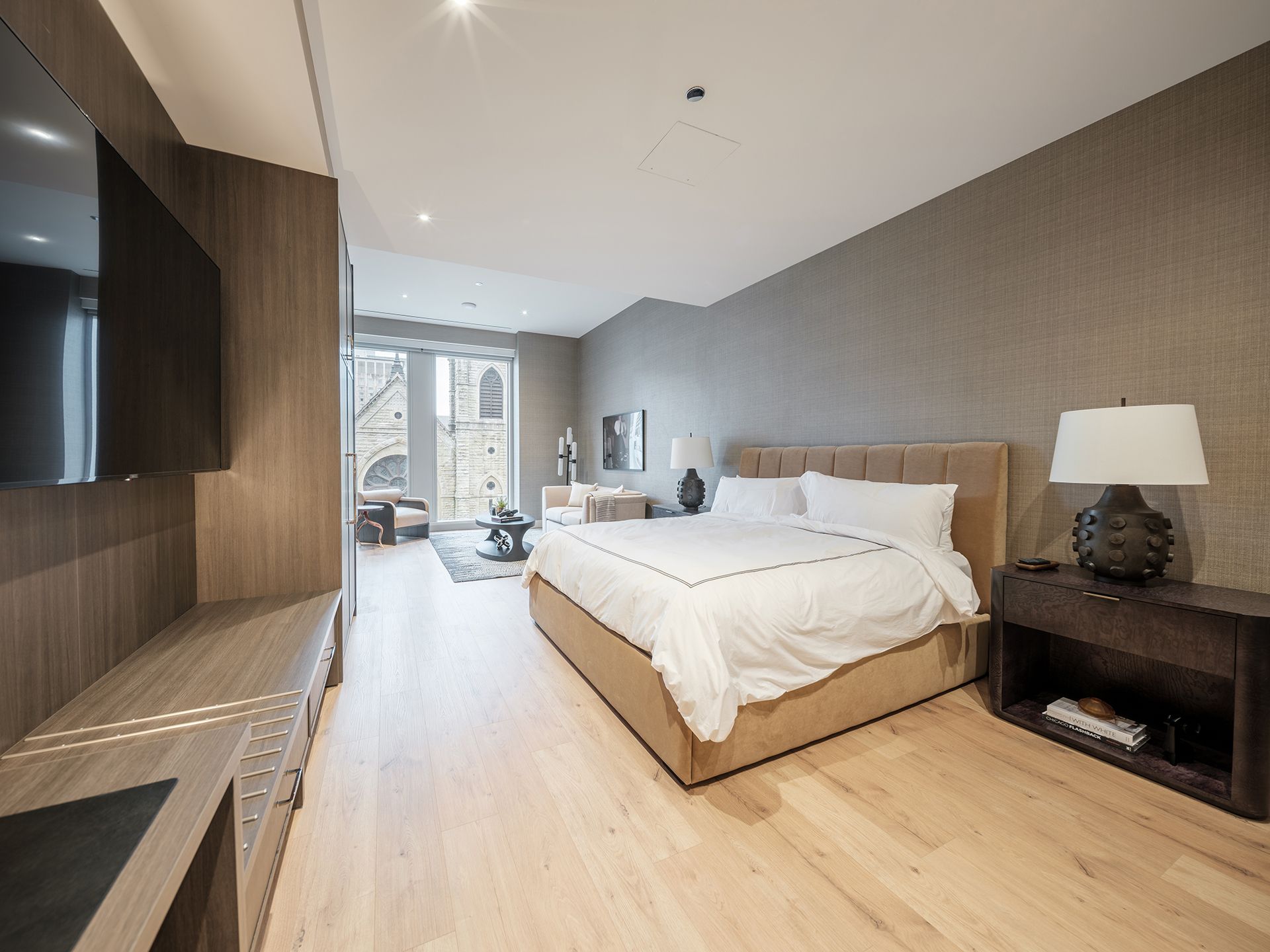 A bedroom with a large bed and a flat screen tv