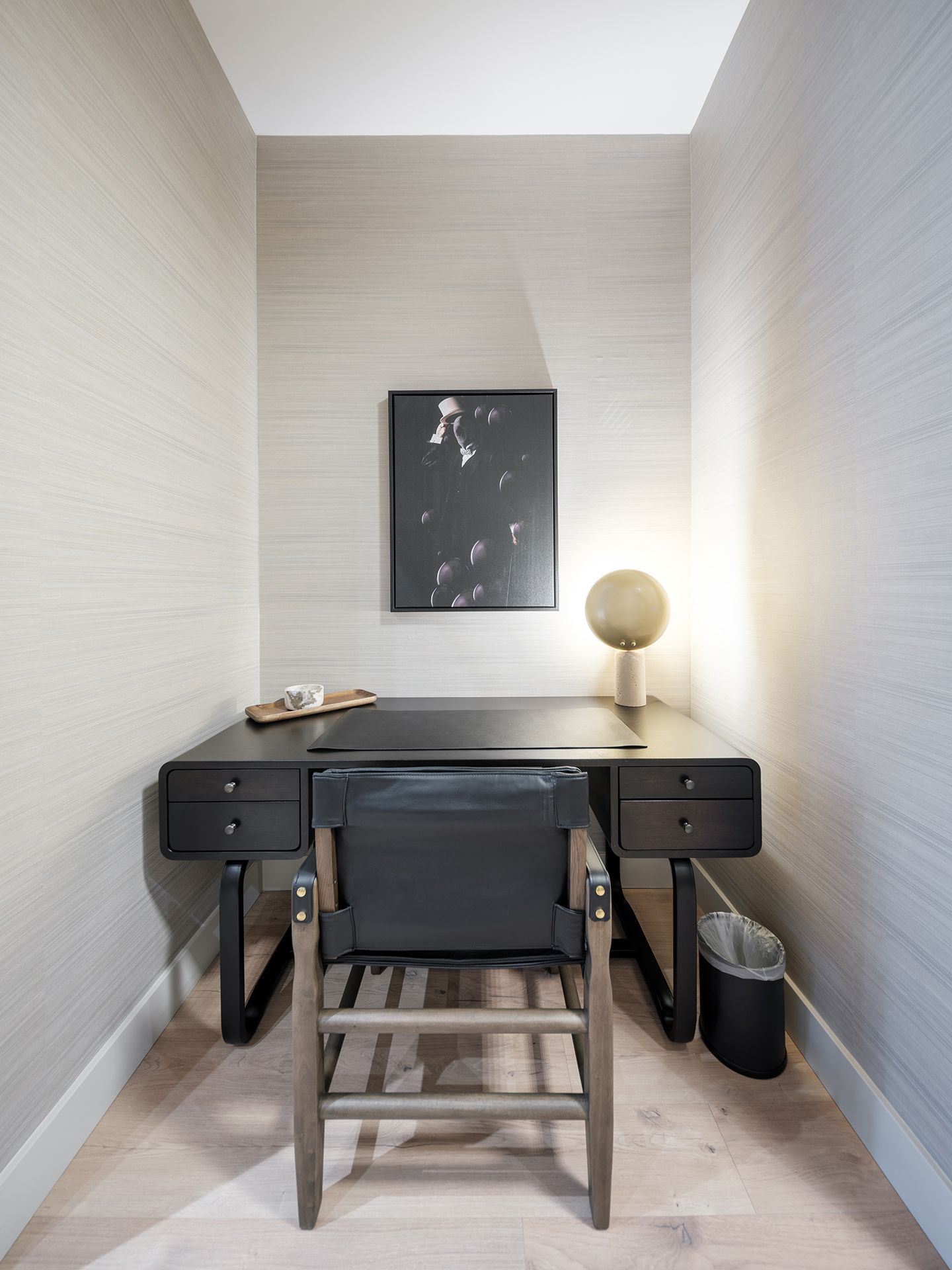 There is a desk and chair in the corner of the room.