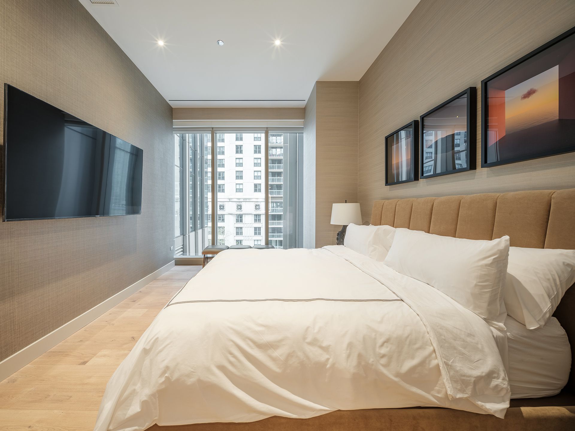A bedroom with a large bed and a flat screen tv
