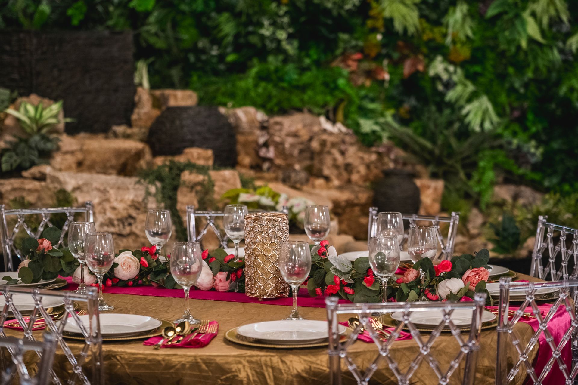 A restaurant table set with plates, glasses, and silverware; ready for guests. The setting is outdoors, with neutral tones.