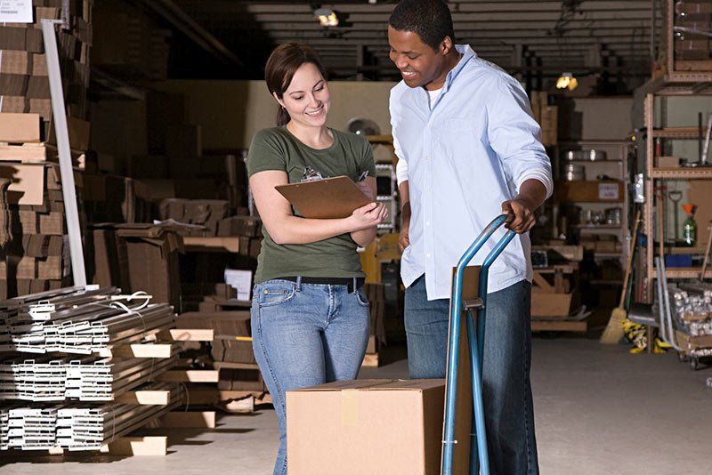 man and woman standing in storage unit