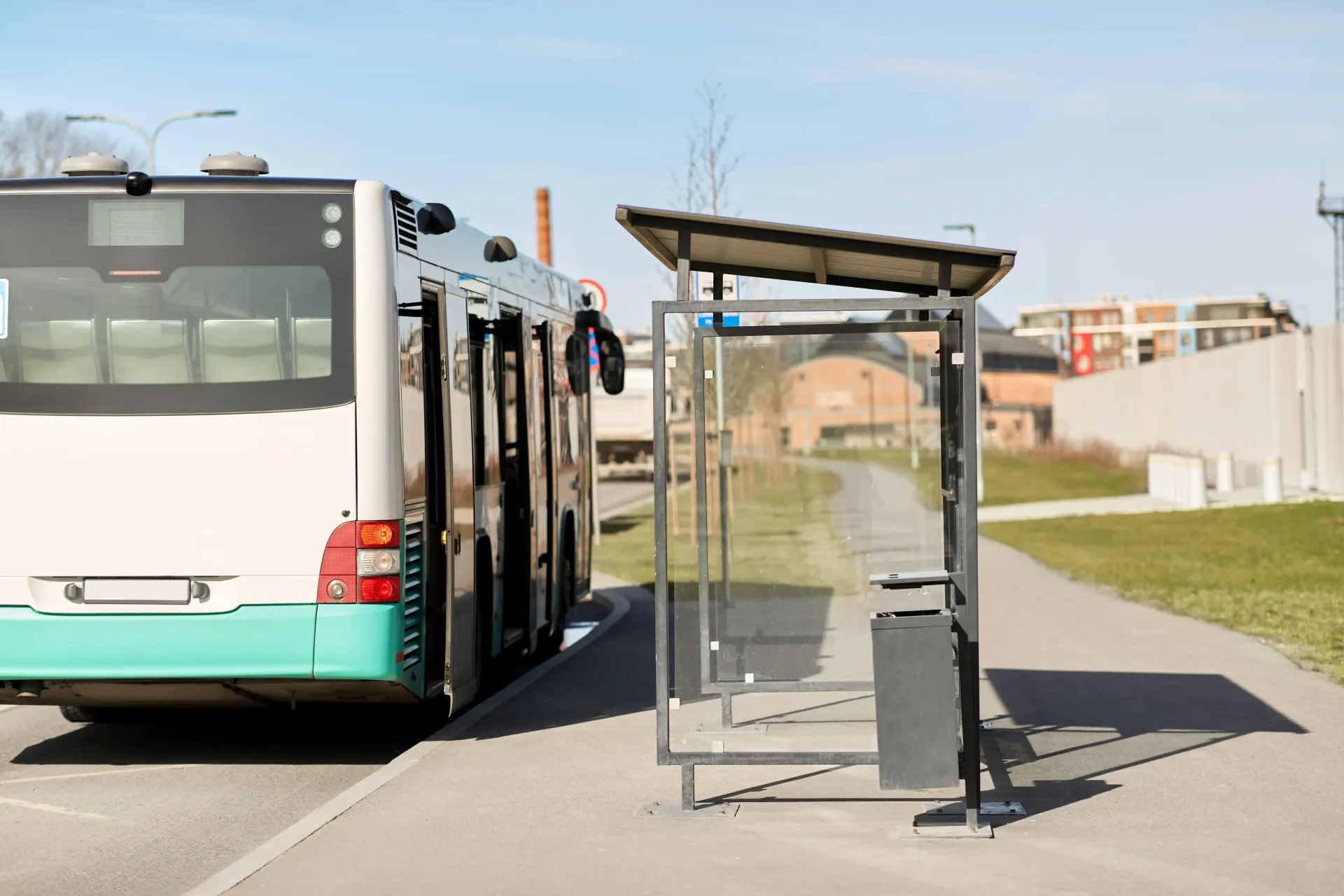 A bus is stopped at a bus stop on the side of the road.