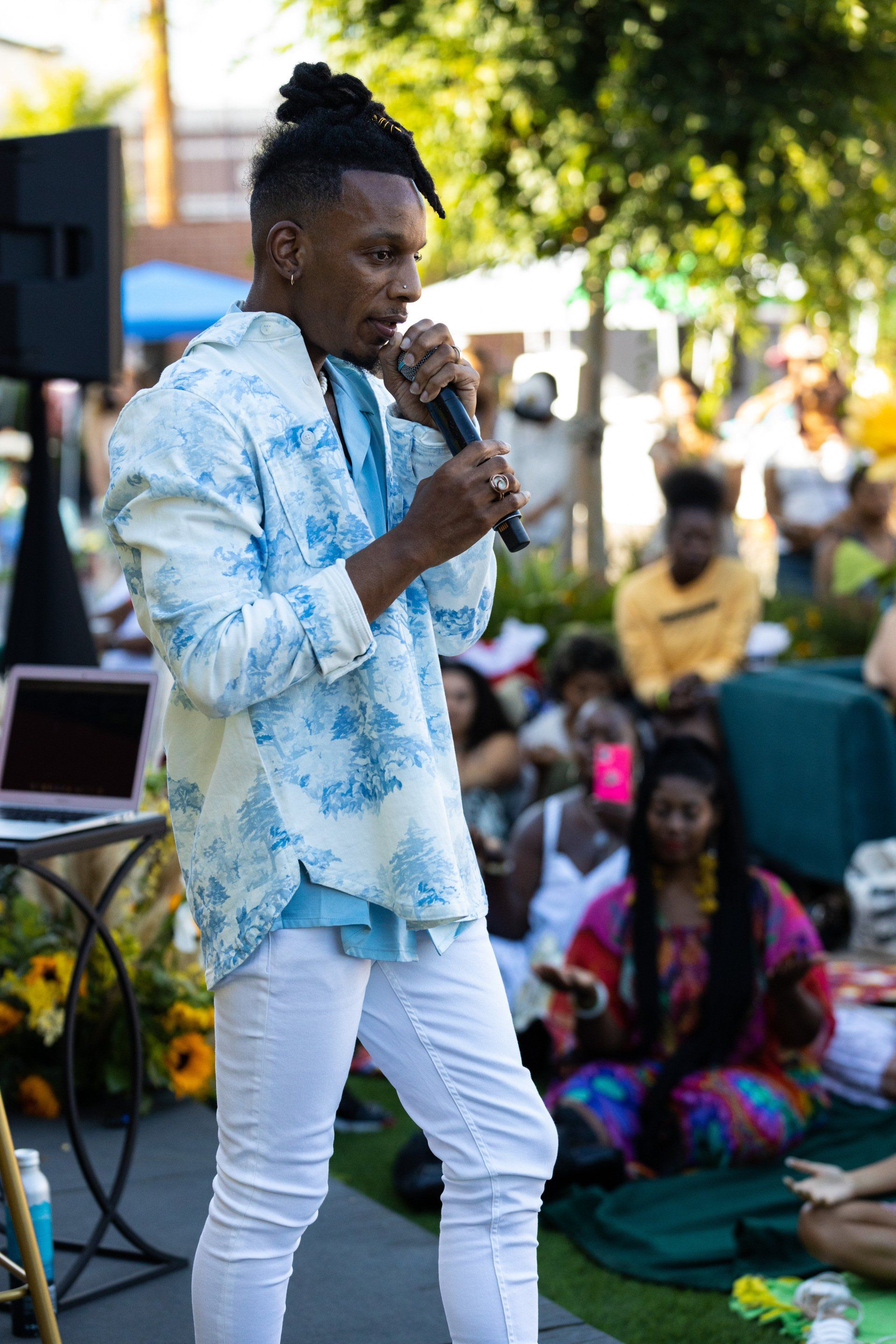 Music Artist Londrelle is standing in front of a crowd holding a microphone at Sol & Sound Festival