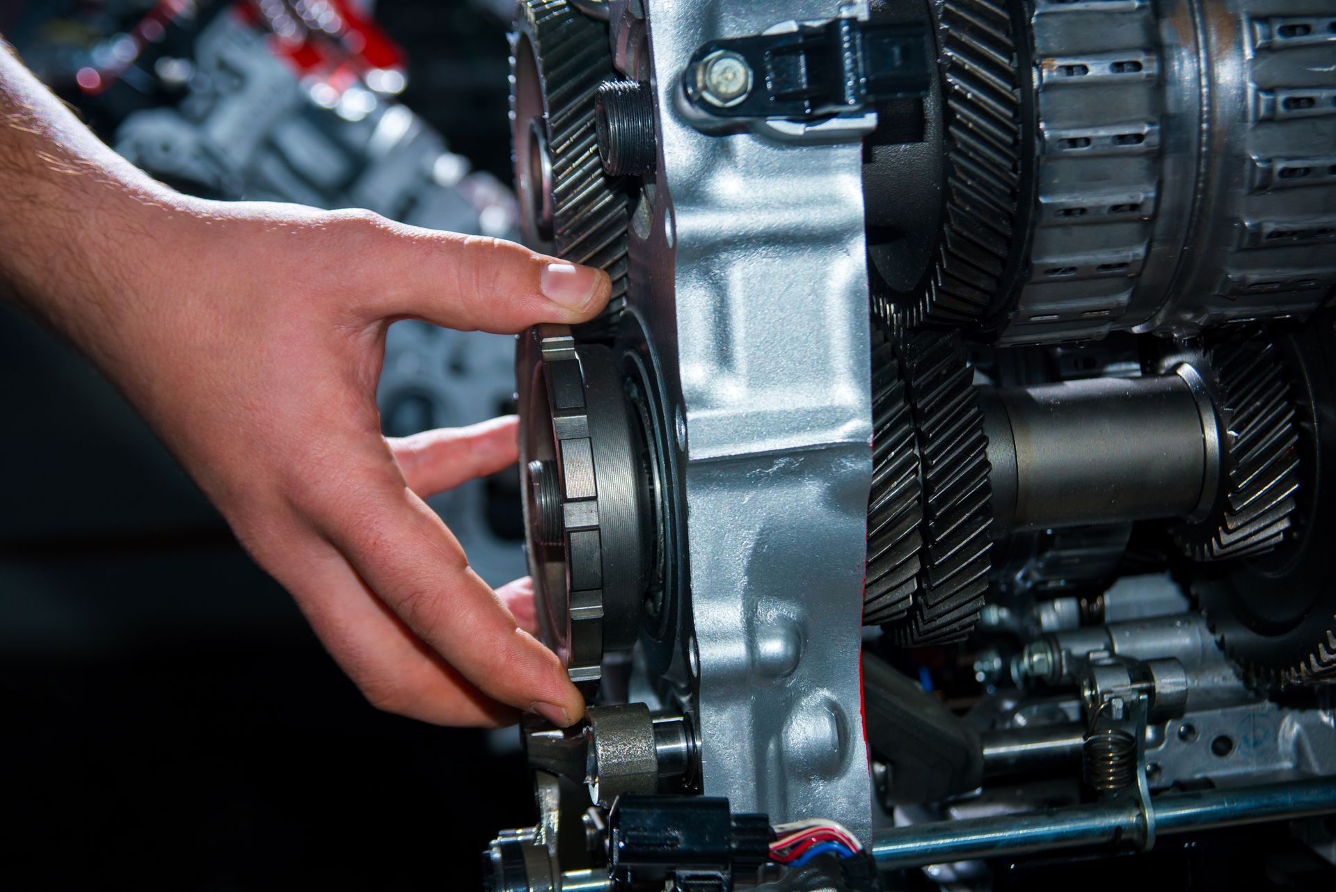 Hand adjusting a gear inside a metal machine assembly