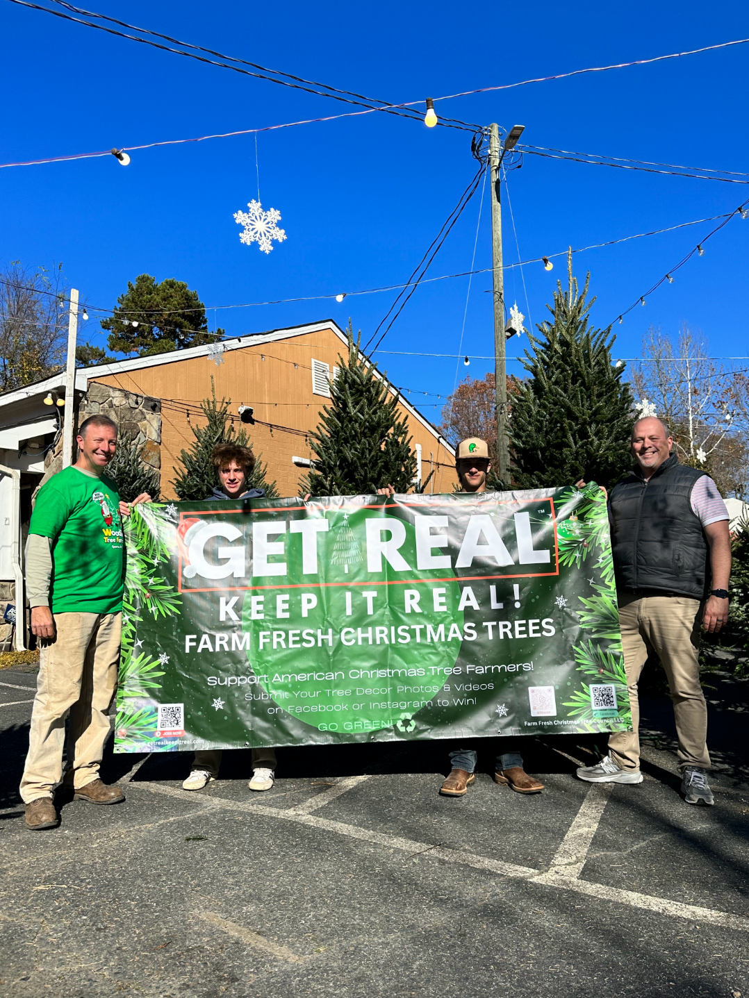A group of men are holding a sign that says `` get real keep it real ''.