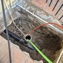 A pipe is being installed in a hole in the ground.