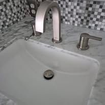 A bathroom sink with a faucet and a drain.