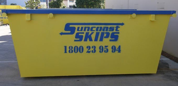Yellow Skip Bin On Driveway — Suncoast Skips in Coolum Beach, QLD