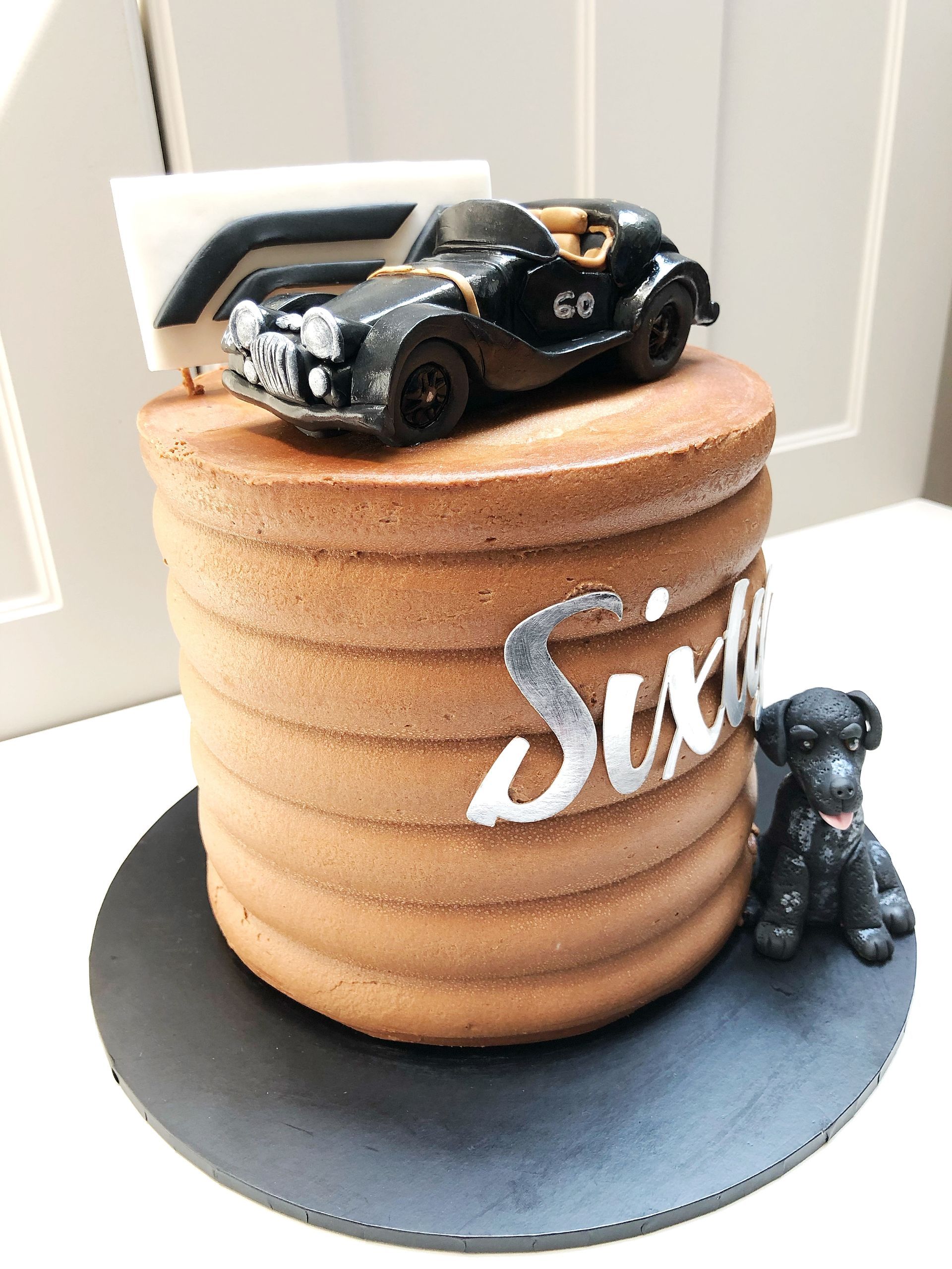 Chocolate cake with F1 logo, fondant Morgan Plus 4 car and dog to decorate the cake. Silver 