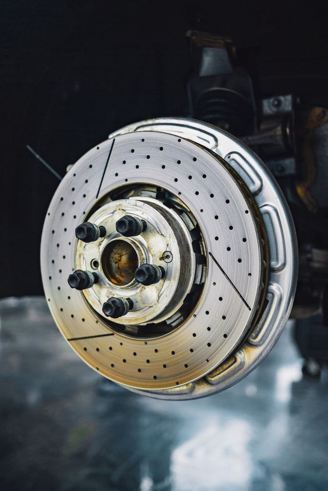 A close up of a brake disc on a car.