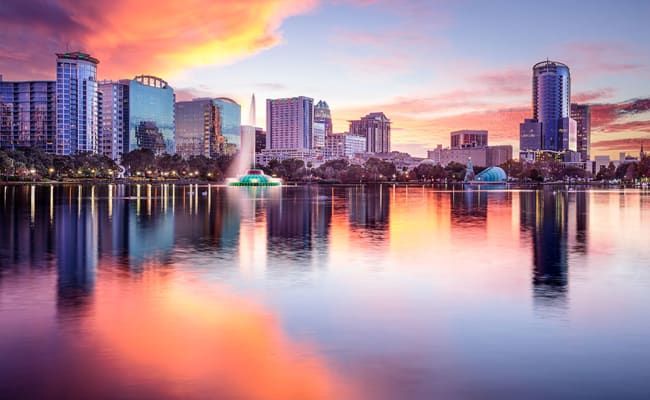 A woman is sitting on a yoga mat at Livano Wildwood