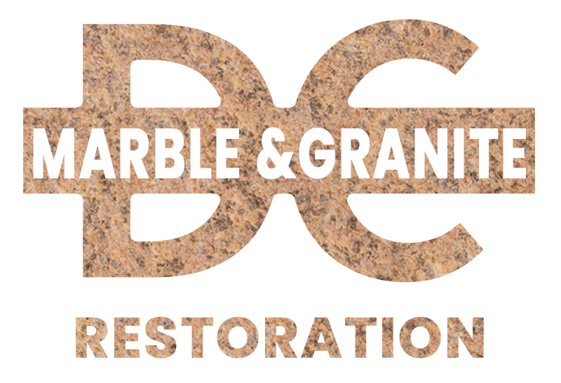 Pile of grey rocks with text "D C Marble and Granite Restoration" on a marble background.