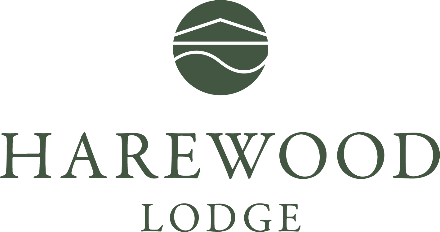 The logo for harewood lodge has a green circle with a house on it.