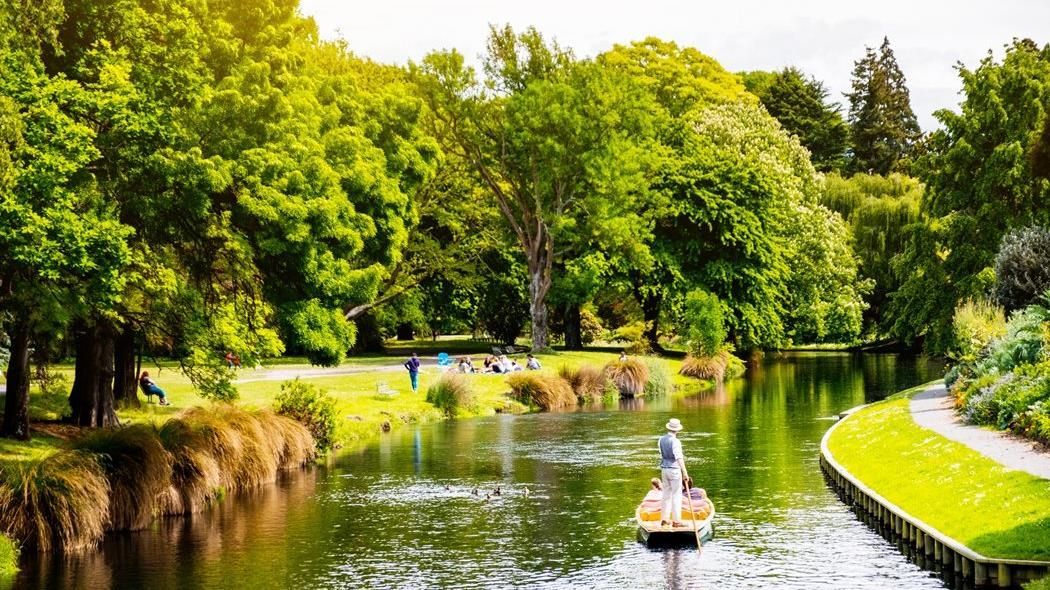 A boat is floating on a river in a park.